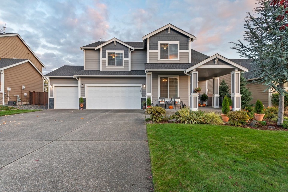 Exposed aggregate concrete driveway leading up to a home at dusk